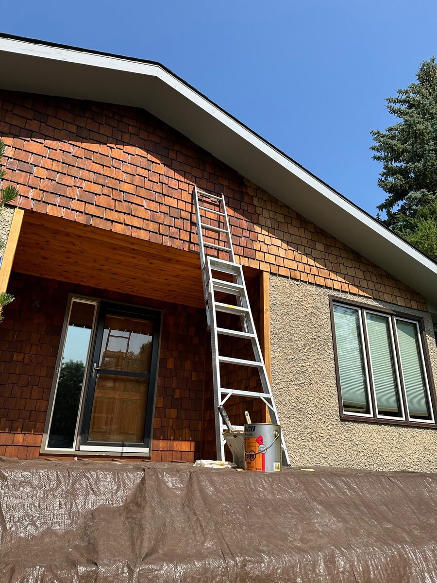 Cedar shake siding being stained, work in progress