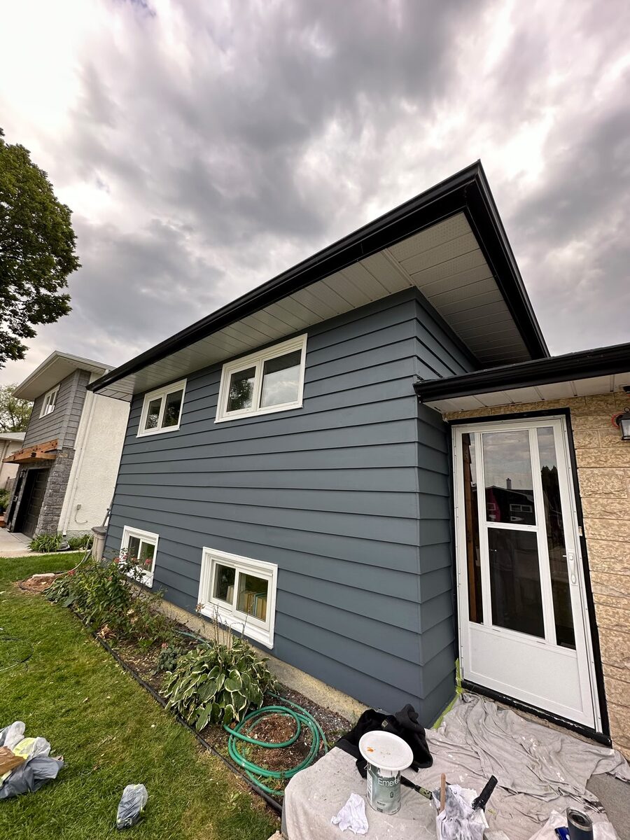 Finished gray-painted exterior siding on a Calgary home