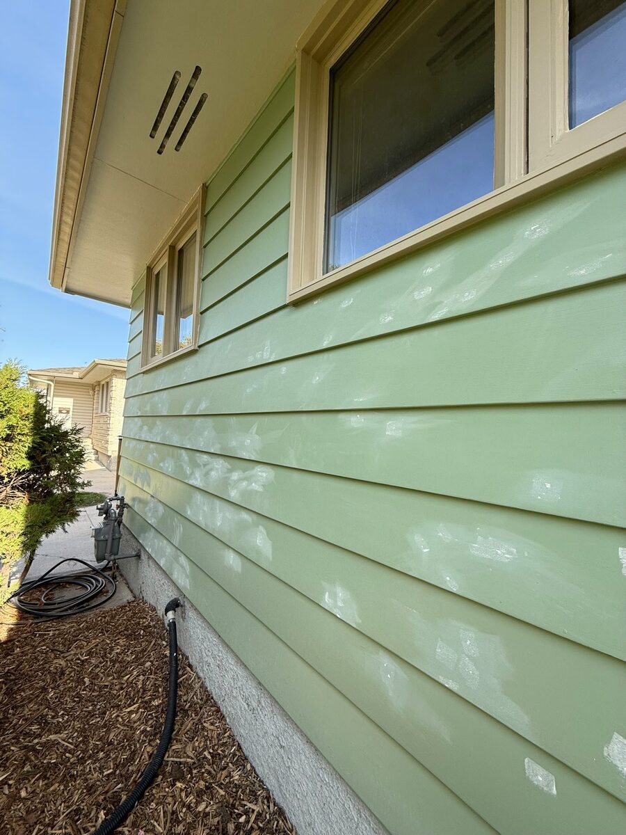 Detail of freshly painted green exterior siding